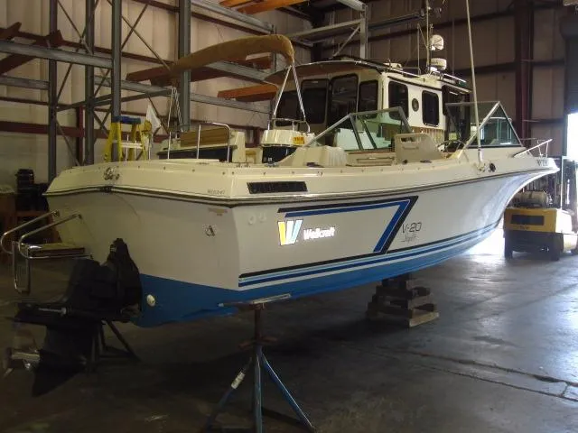 Slide: The Image of 1987 Wellcraft Step V 20 boat in a warehouse, elevated on stands. - 2