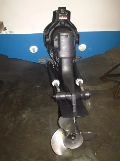 Slide: The Image of 1987 Wellcraft Step V 20 boat engine and propeller, displayed indoors on a concrete floor. - 3