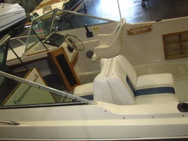 Slide: The Image of 1987 Wellcraft Step V 20 boat interior with white and blue seating, steering wheel, and dashboard. - 7