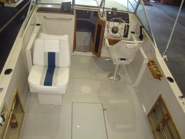 Slide: The Image of 1987 Wellcraft Step V 20 boat interior with white seating and steering wheel. - 8