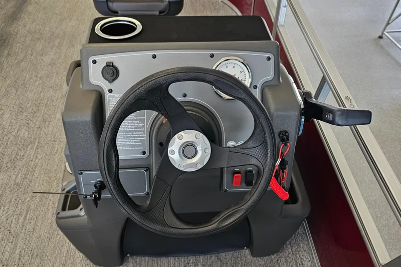 Slide: The Image of Steering console of 2026 Sun Tracker BB-16 XL Select boat with cup holder and controls. - 10
