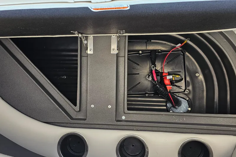 Slide: The Image of Open storage compartment in 2026 Sun Tracker BB-16 XL Select boat, showing wiring and cup holders. - 13