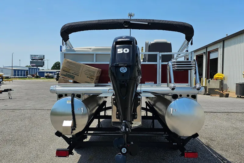 Slide: The Image of 2026 Sun Tracker BB-16 XL Select pontoon boat with Mercury 50 engine, parked outdoors. - 2