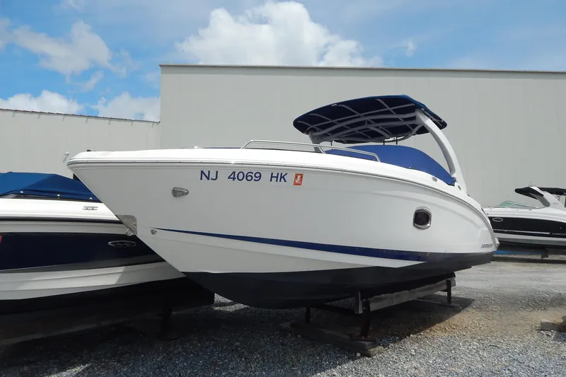 Slide: The Image of 2016 Chaparral 277 SSX boat with blue canopy, docked outdoors. - 1