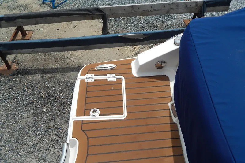 Slide: The Image of 2016 Chaparral 277 SSX boat with teak swim platform and blue cover. - 14