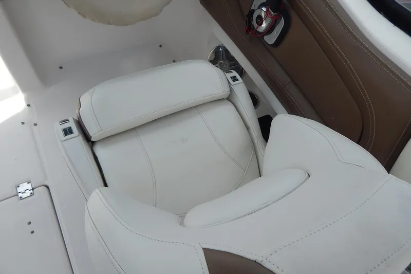 Slide: The Image of 2016 Chaparral 277 SSX boat interior with white and brown seating. - 17