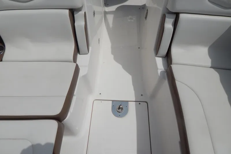 Slide: The Image of Interior seating of 2016 Chaparral 277 SSX boat, featuring white and brown upholstery. - 26
