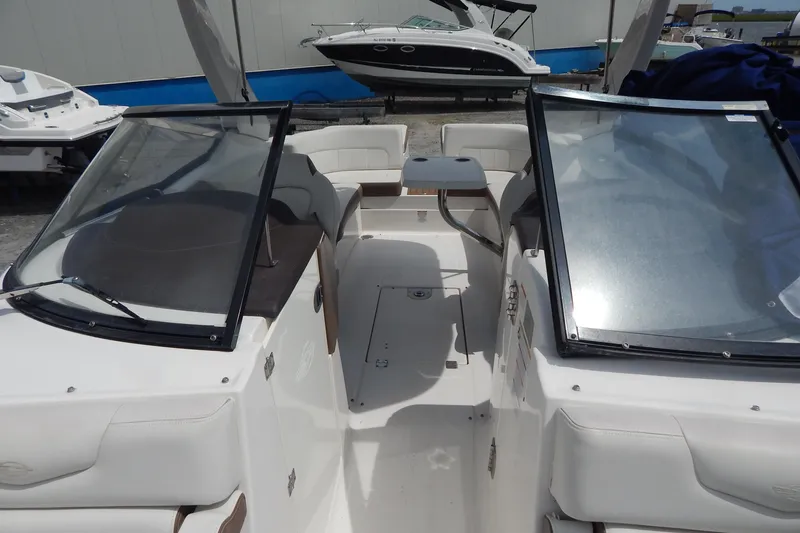 Slide: The Image of 2016 Chaparral 277 SSX boat interior with dual windshields and seating area. - 28