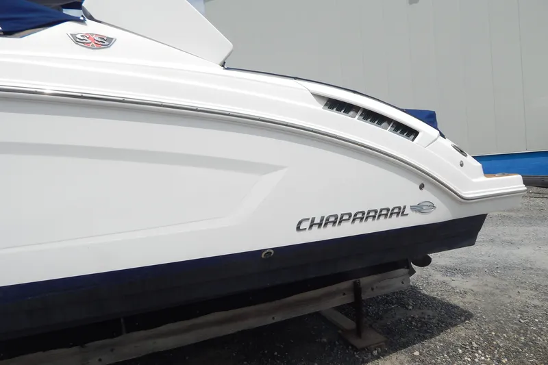 Slide: The Image of 2016 Chaparral 277 SSX boat side view with logo and sleek design. - 3