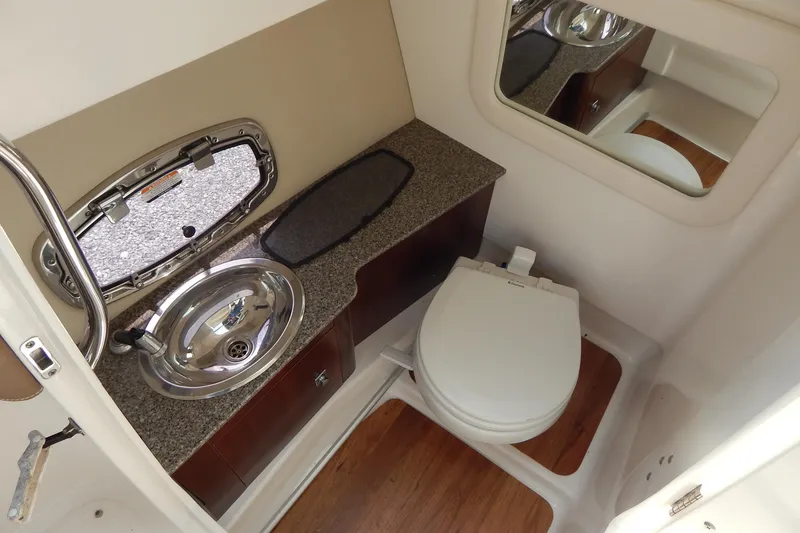 Slide: The Image of 2016 Chaparral 277 SSX boat bathroom with sink, toilet, and mirror. - 33