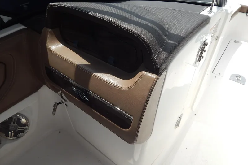 Slide: The Image of 2016 Chaparral 277 SSX boat interior with brown and black dashboard details. - 34