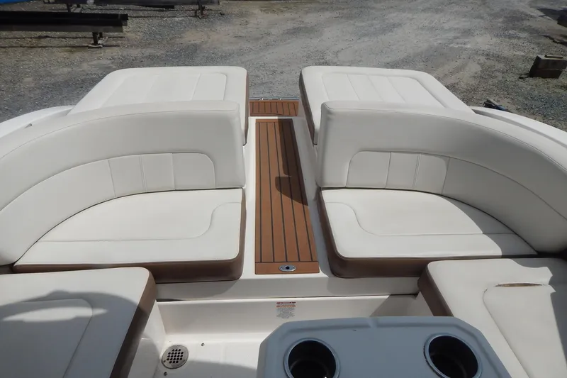 Slide: The Image of 2016 Chaparral 277 SSX boat interior with white cushioned seating and wood accents. - 35