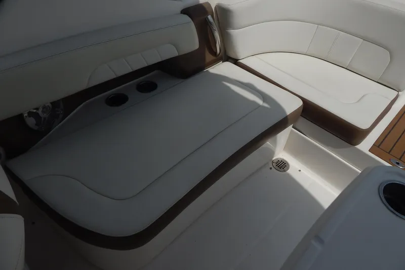 Slide: The Image of Interior seating of 2016 Chaparral 277 SSX boat with white and brown upholstery. - 36