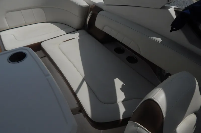 Slide: The Image of 2016 Chaparral 277 SSX boat interior with white leather seating and cup holders. - 37