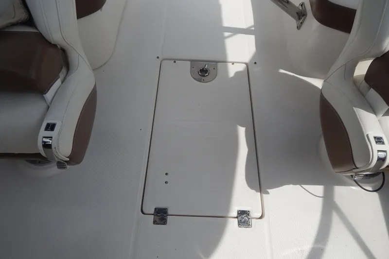 Slide: The Image of 2016 Chaparral 277 SSX boat interior with white and brown seating. - 46