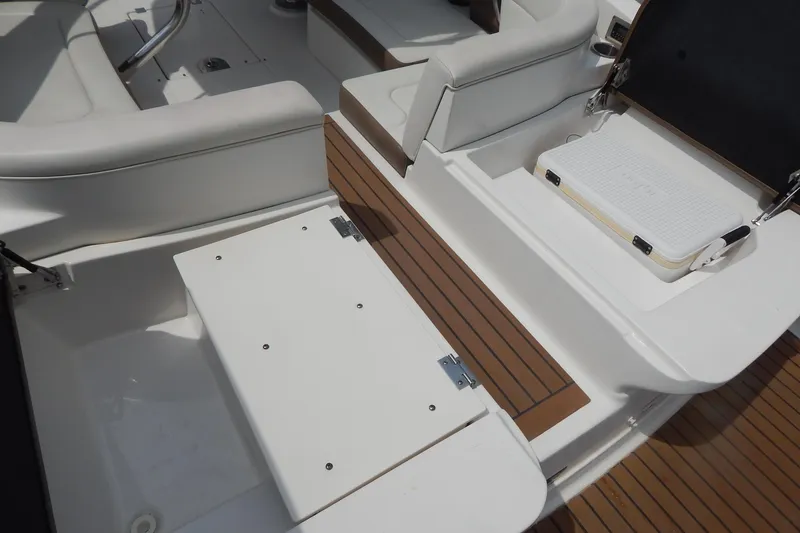 Slide: The Image of 2016 Chaparral 277 SSX boat interior with white seating and wood accents. - 47