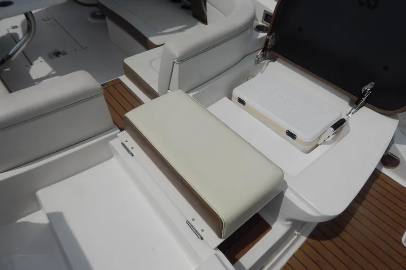 Slide: The Image of 2016 Chaparral 277 SSX boat interior with seating and storage compartment. - 48