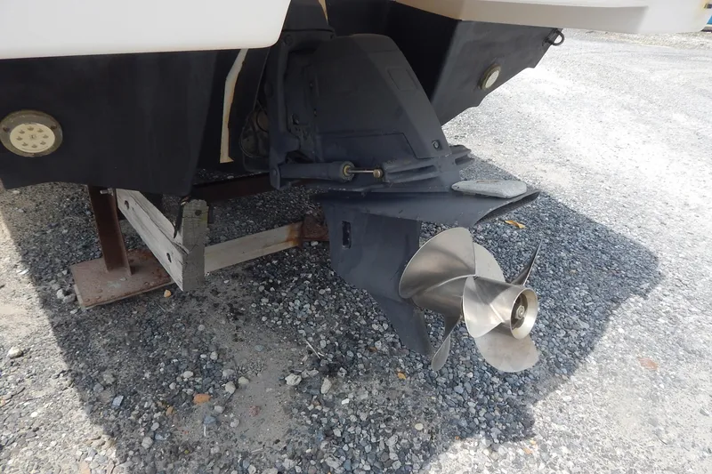Slide: The Image of 2016 Chaparral 277 SSX boat propeller and stern drive on gravel surface. - 6