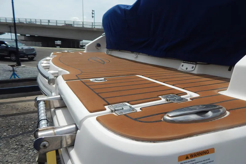 Slide: The Image of 2016 Chaparral 277 SSX boat with teak-style swim platform and covered seating area. - 9