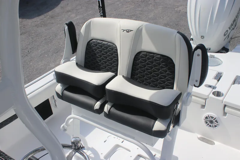 Slide: The Image of 2026 Tidewater 2500 Carolina Bay boat interior with storage compartments and seating. - 13
