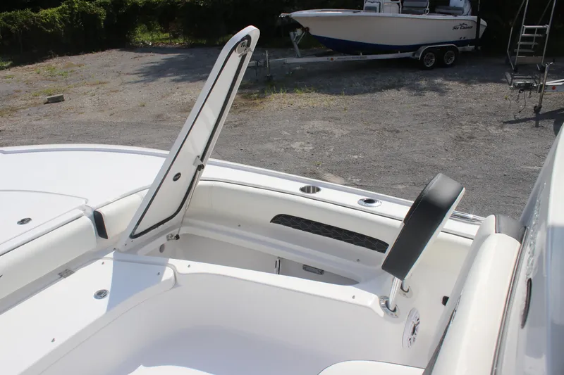 Slide: The Image of 2026 Tidewater 2500 Carolina Bay boat seat with storage compartment open. - 25