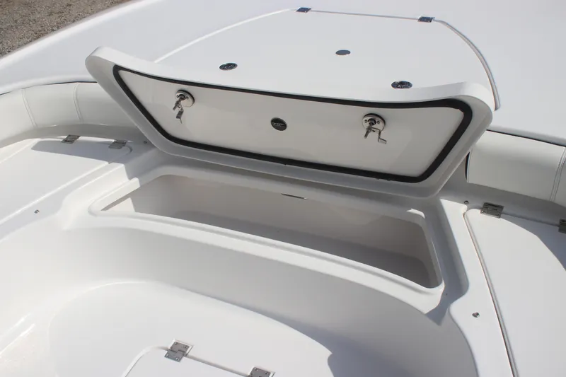 Slide: The Image of Hatch compartment on 2026 Tidewater 2500 Carolina Bay boat, featuring a storage bucket. - 26