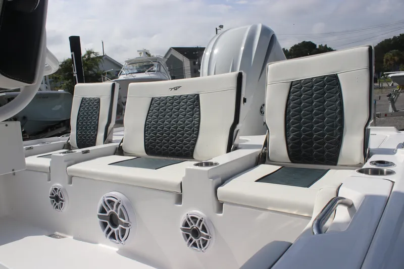 Slide: The Image of 2026 Tidewater 2500 Carolina Bay boat console with modern controls and seating. - 4