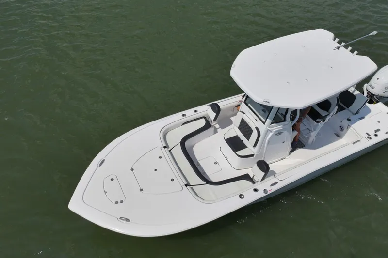 Slide: The Image of 2026 Tidewater 2500 Carolina Bay boat on trailer, parked outdoors under clear sky. - 6