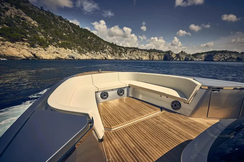 Slide: The Image of Luxurious 2023 Frauscher 1414 Demon yacht with elegant seating, cruising near scenic coastline. - 5