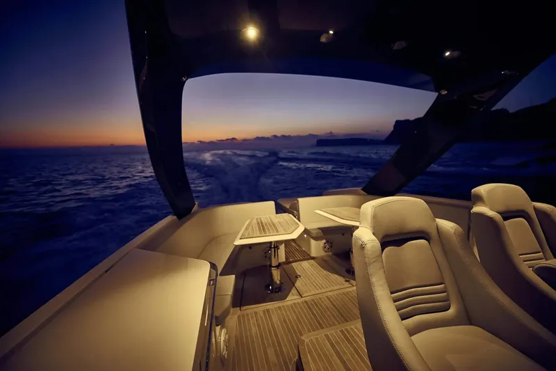 Slide: The Image of Luxury Frauscher 1414 Demon yacht interior at sunset, 2023 model, elegant seating and ocean view. - 8