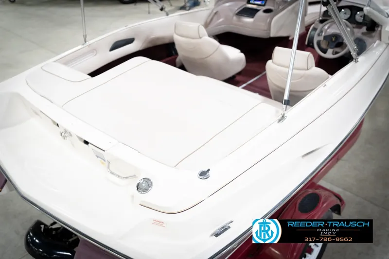Slide: The Image of 1998 Regal 1700 LSR boat interior with white seating and dashboard, Reeder-Trausch Marine logo visible. - 13