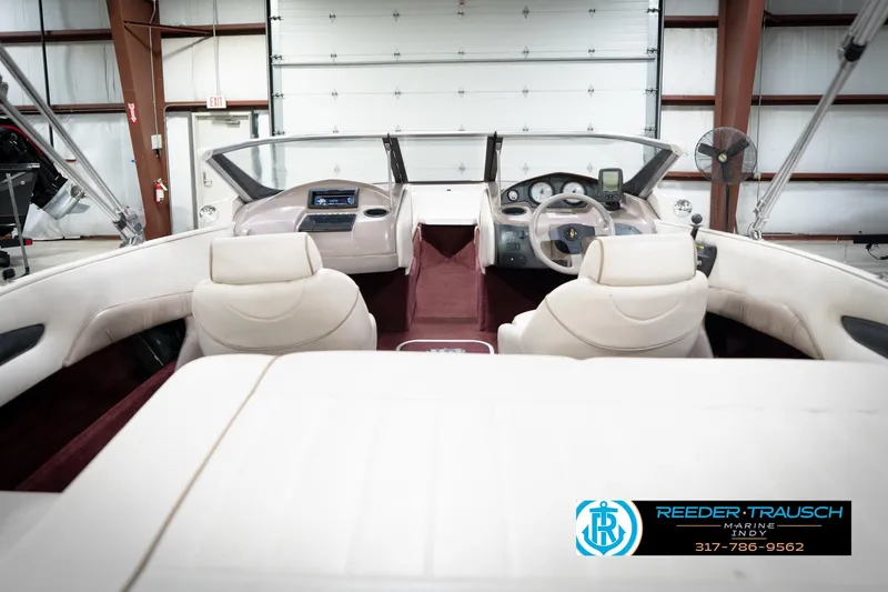 Slide: The Image of Interior of a 1998 Regal 1700 LSR boat with beige seating and dashboard. - 15