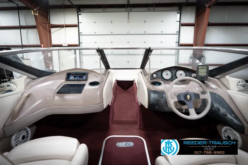 Slide: The Image of 1998 Regal 1700 LSR boat interior with dashboard and steering wheel in a garage setting. - 16