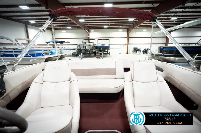 Slide: The Image of 1998 Regal 1700 LSR boat interior with beige seating in a showroom. - 19