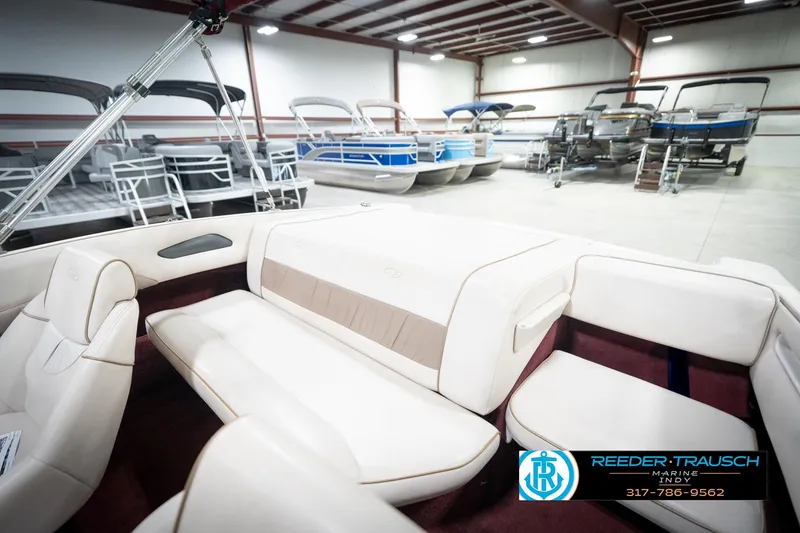 Slide: The Image of 1998 Regal 1700 LSR boat interior in showroom with other boats displayed. - 20