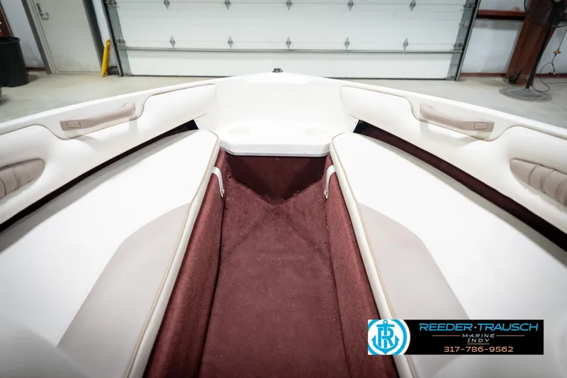 Slide: The Image of Interior view of a 1998 Regal 1700 LSR boat with white seating and maroon carpet. - 22
