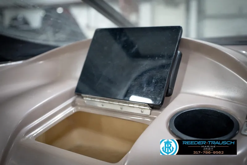 Slide: The Image of Dashboard of a 1998 Regal 1700 LSR boat with storage compartment and cup holder. - 25