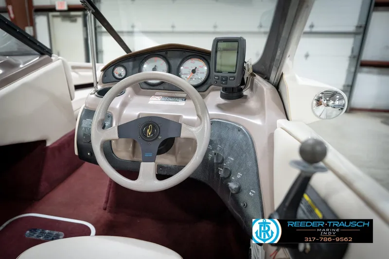 Slide: The Image of 1998 Regal 1700 LSR boat dashboard with steering wheel and gauges in a showroom. - 26