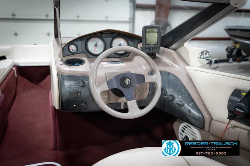 Slide: The Image of Interior of a 1998 Regal 1700 LSR boat with steering wheel and dashboard controls. - 27
