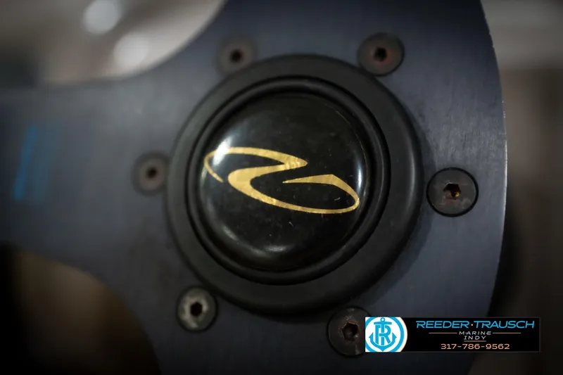 Slide: The Image of Close-up of Regal 1700 LSR 1998 steering wheel with logo and Reeder-Trausch Marine contact. - 28