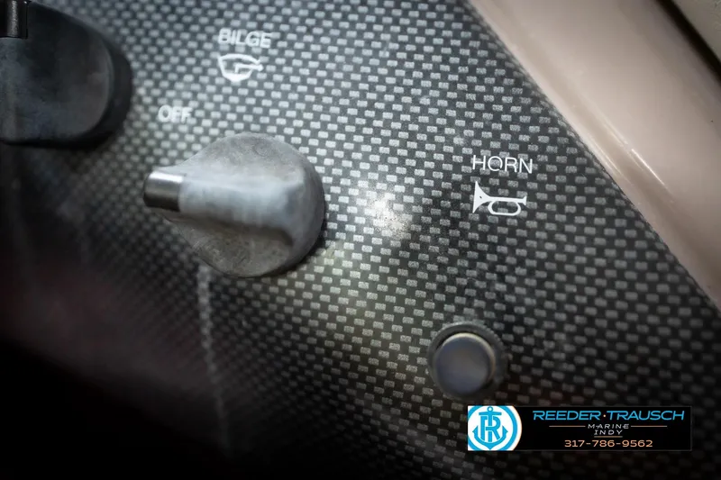 Slide: The Image of Dashboard controls of a 1998 Regal 1700 LSR boat, featuring bilge and horn switches. - 35