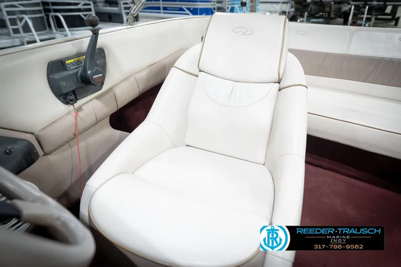 Slide: The Image of 1998 Regal 1700 LSR boat interior with white seating and control panel. - 37