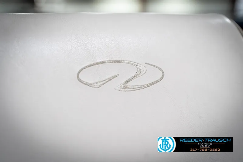 Slide: The Image of White leather seat with embossed logo, Regal 1700 LSR 1998, Reeder-Trausch Marine contact info. - 38