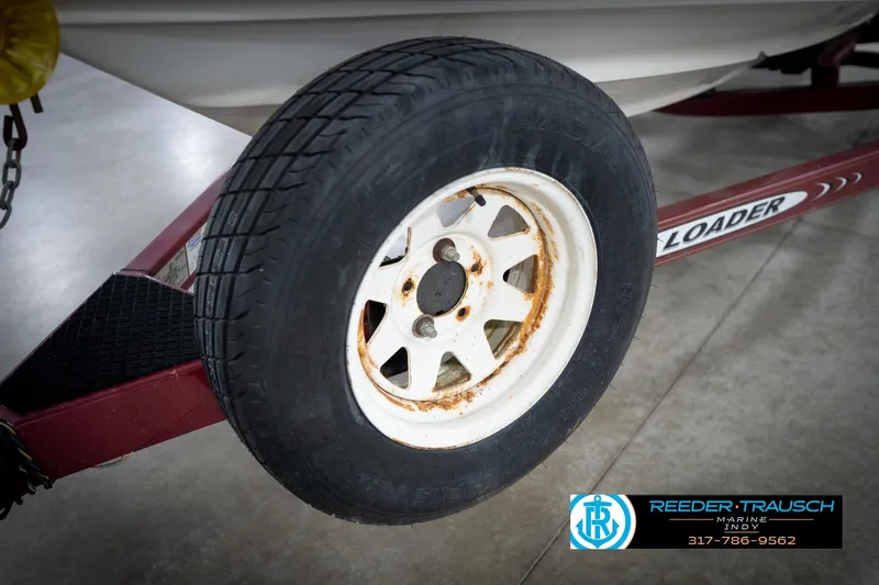 Slide: The Image of Trailer wheel of a 1998 Regal 1700 LSR boat, showing rust and wear. - 49