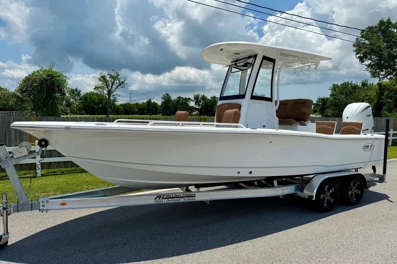 The Image of 2026 Sea Hunt BX25FS boat on trailer, parked outdoors under cloudy sky. - 1