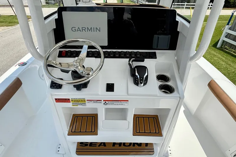 Slide: The Image of 2026 Sea Hunt BX25FS boat console with Garmin display and steering wheel. - 11