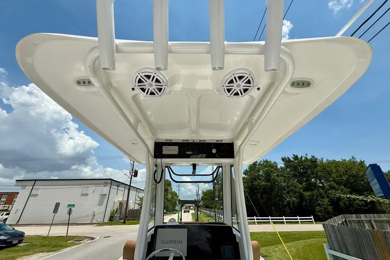 Slide: The Image of 2026 Sea Hunt BX25FS boat with speakers and Garmin equipment under a clear sky. - 12