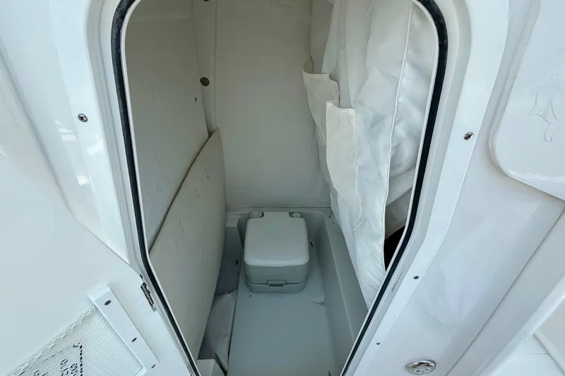 Slide: The Image of 2026 Sea Hunt BX25FS boat interior with compact marine toilet. - 14