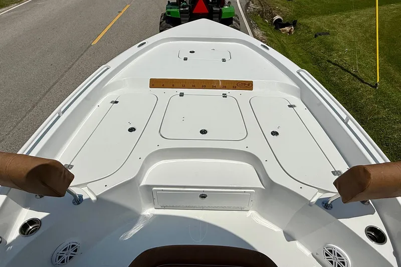 Slide: The Image of 2026 Sea Hunt BX25FS boat deck with storage compartments and cushioned seating. - 16