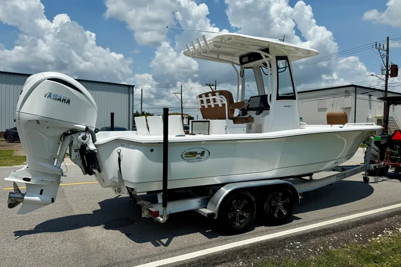 Slide: The Image of 2026 Sea Hunt BX25FS boat on trailer with Yamaha outboard motor, parked on road. - 4